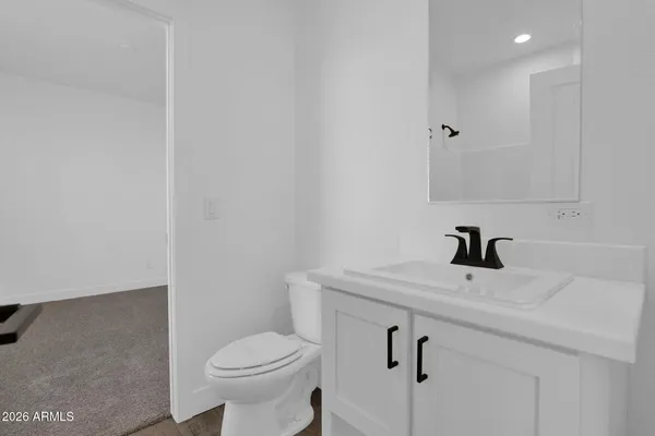 a open kitchen with white cabinets and white appliances