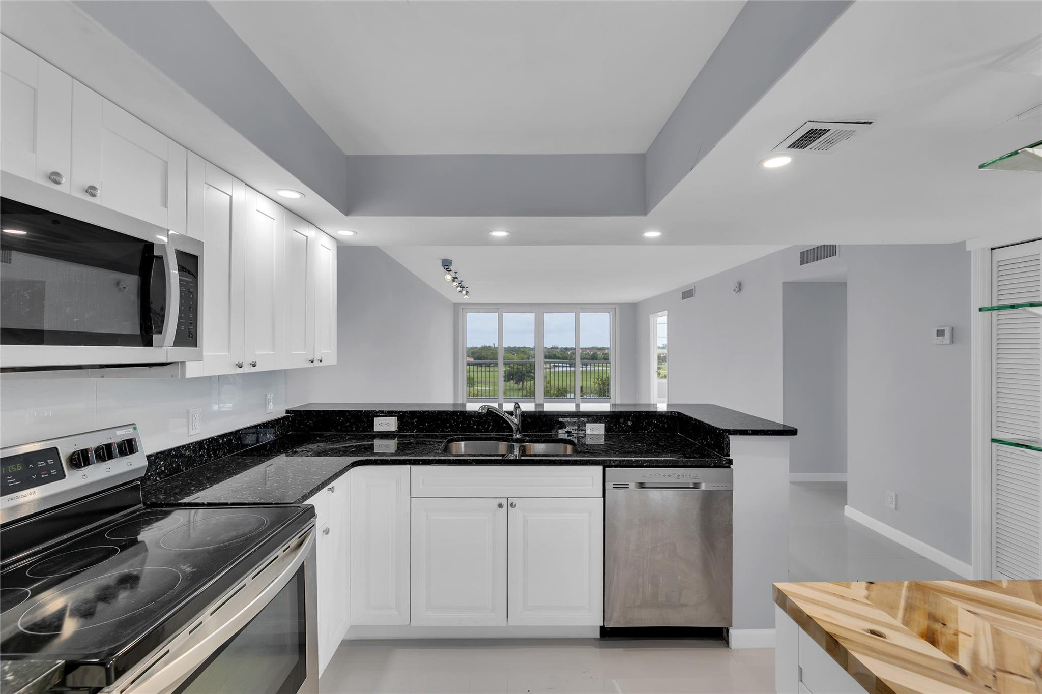 a kitchen with a sink stove and microwave