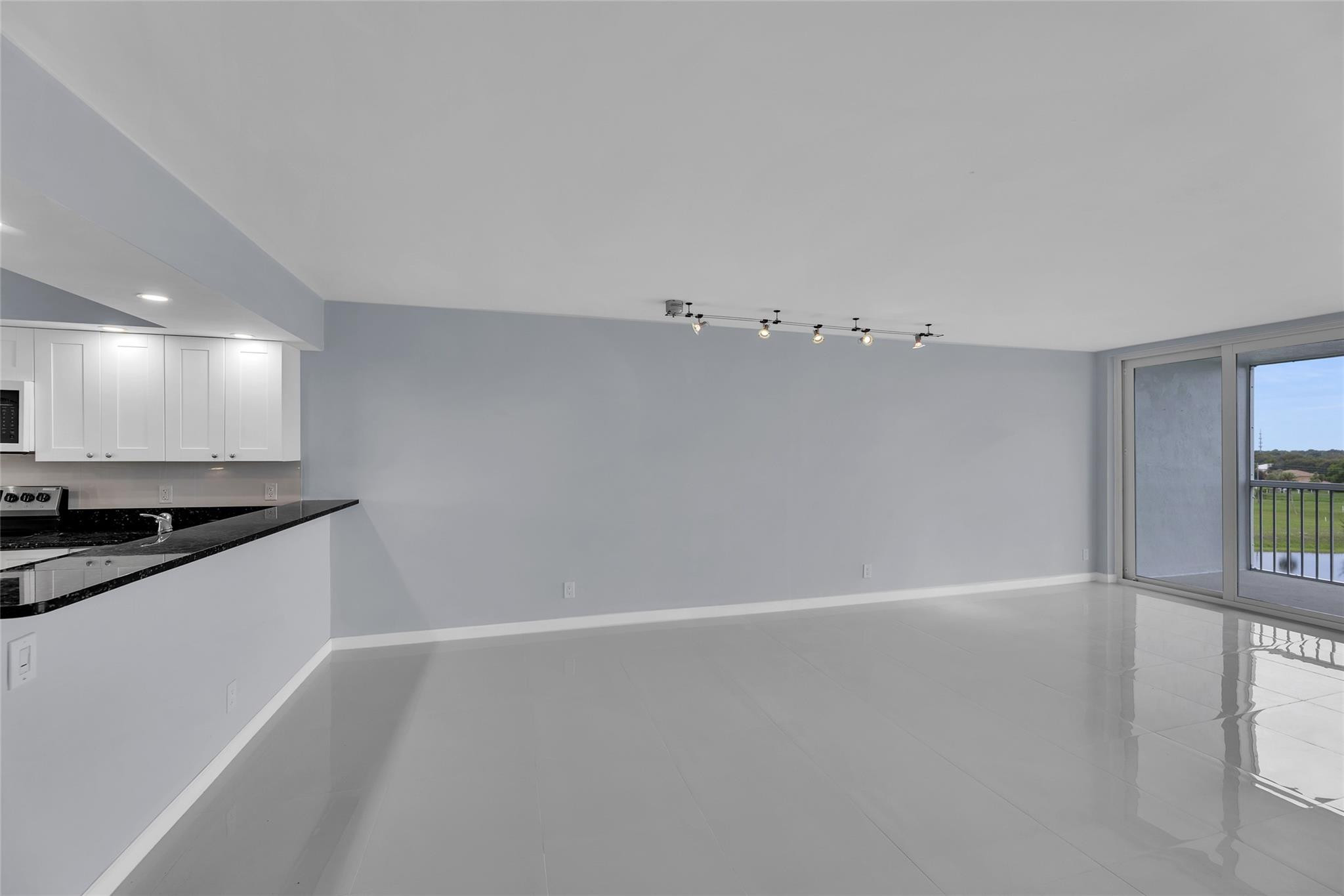 3090 North Course Drive, Unit 609 Pompano Beach, FL 33069 - Photo 13 of 44 a view of a kitchen with a sink and dishwasher a stove top oven with wooden floor