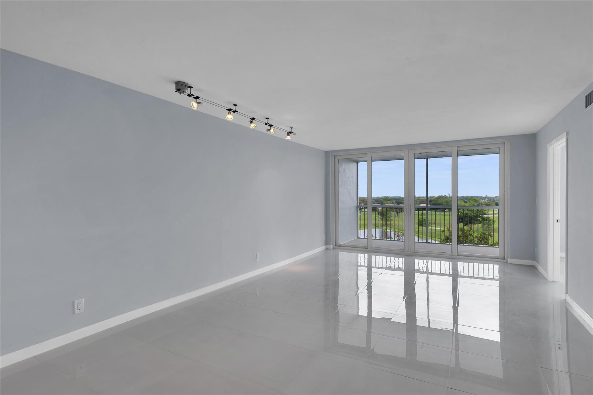 3090 North Course Drive, Unit 609 Pompano Beach, FL 33069 - Photo 14 of 44 wooden floor in an empty room with a window