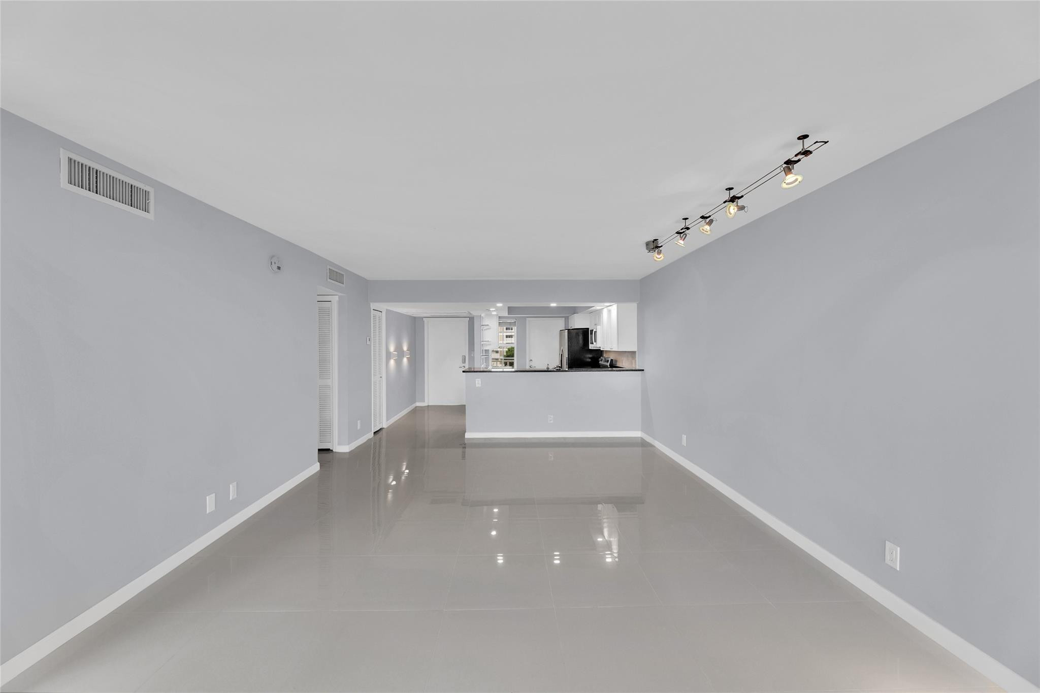 3090 North Course Drive, Unit 609 Pompano Beach, FL 33069 - Photo 15 of 44 a view of empty room with kitchen and window
