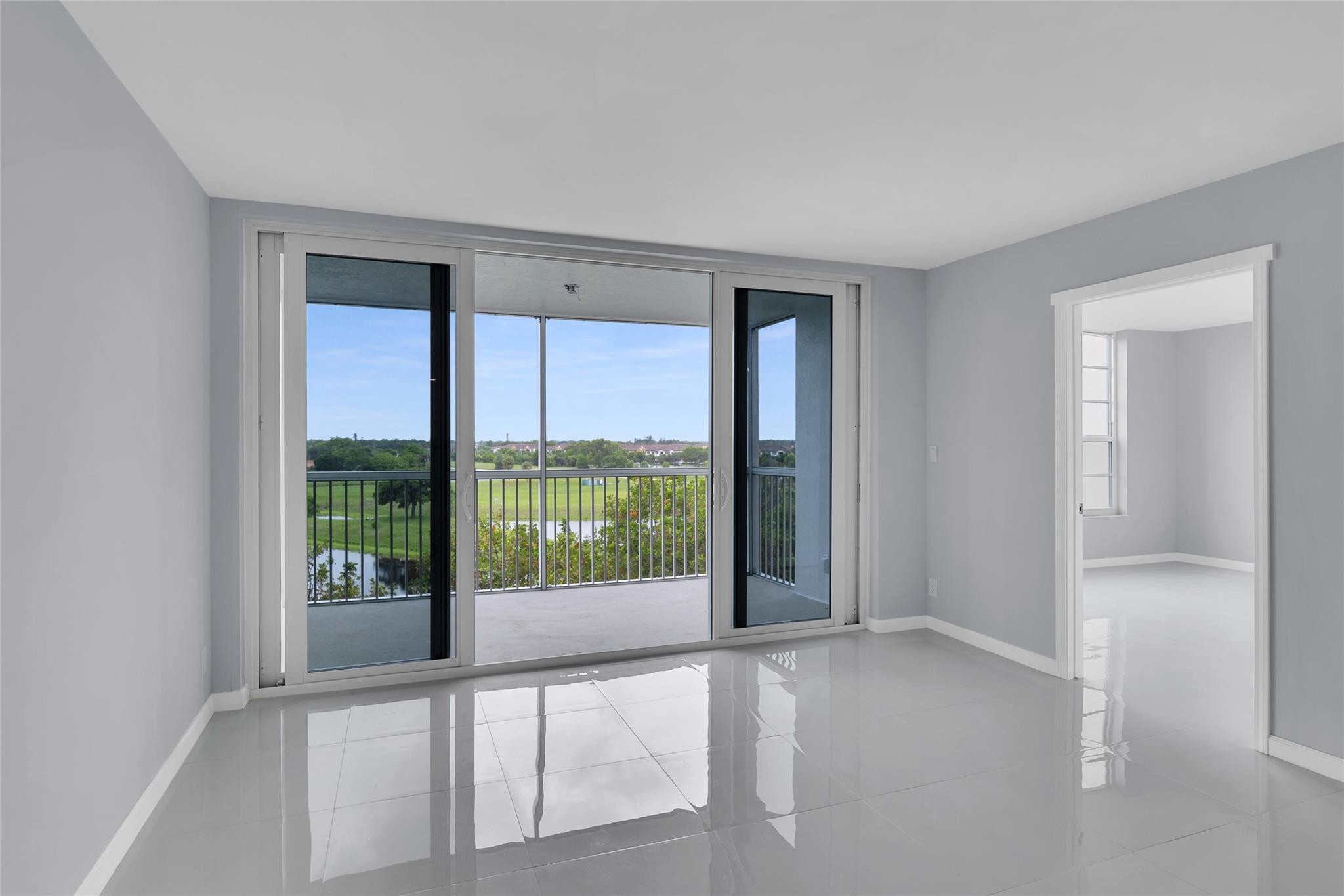 3090 North Course Drive, Unit 609 Pompano Beach, FL 33069 - Photo 17 of 44 wooden floor in an empty room with a window