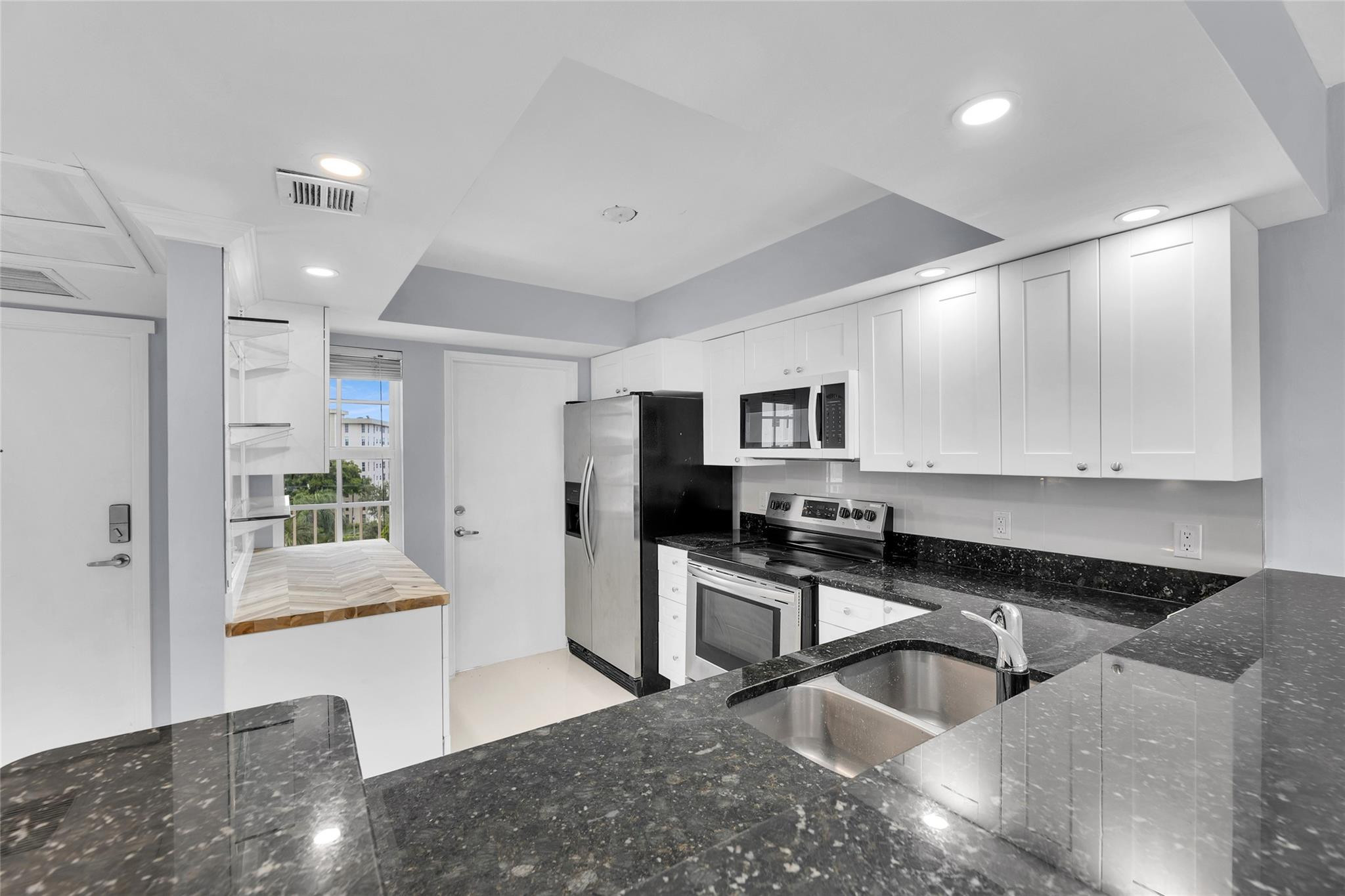 3090 North Course Drive, Unit 609 Pompano Beach, FL 33069 - Photo 2 of 44 a kitchen with stainless steel appliances granite countertop a sink and a stove