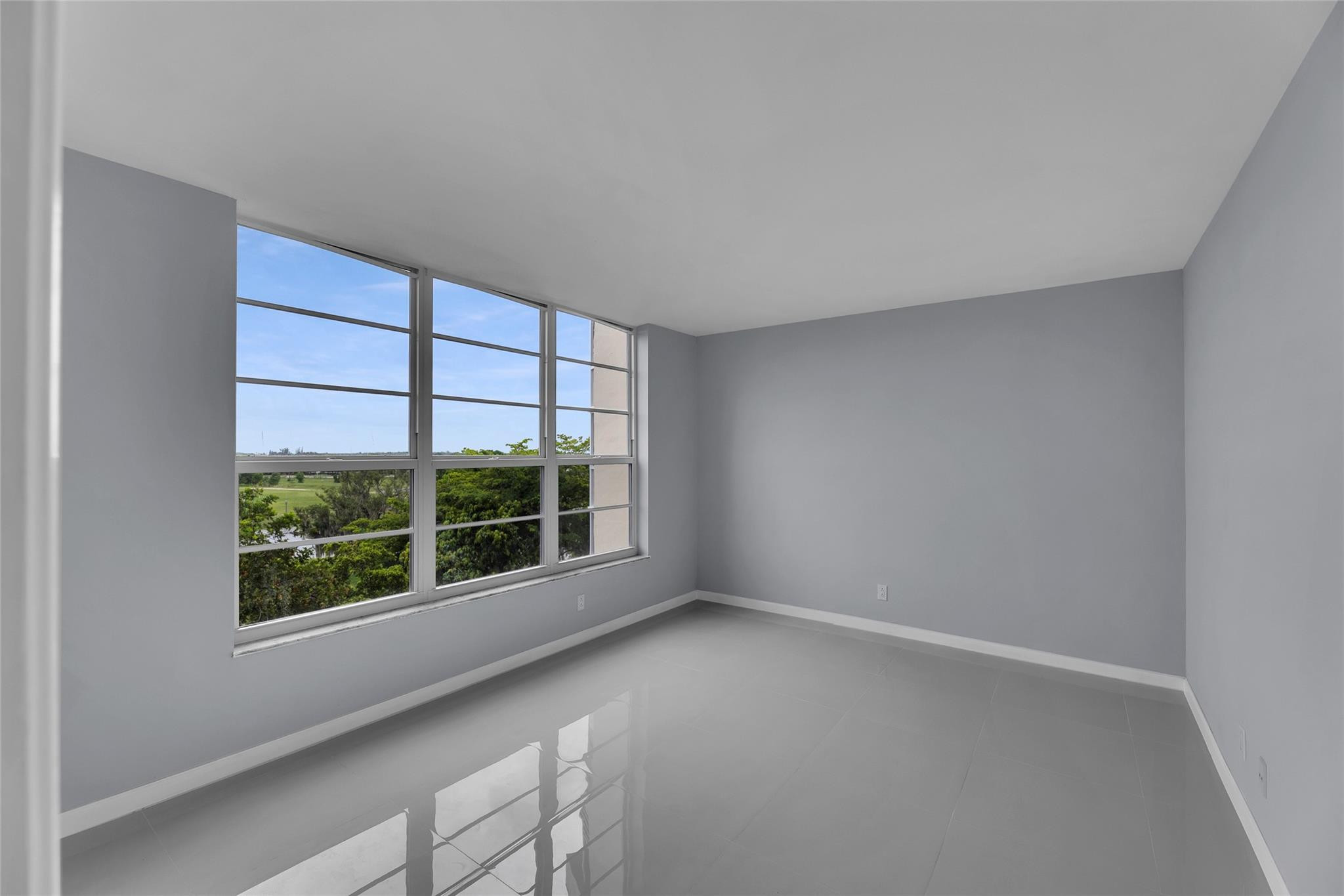 3090 North Course Drive, Unit 609 Pompano Beach, FL 33069 - Photo 22 of 44 wooden floor in an empty room with a window
