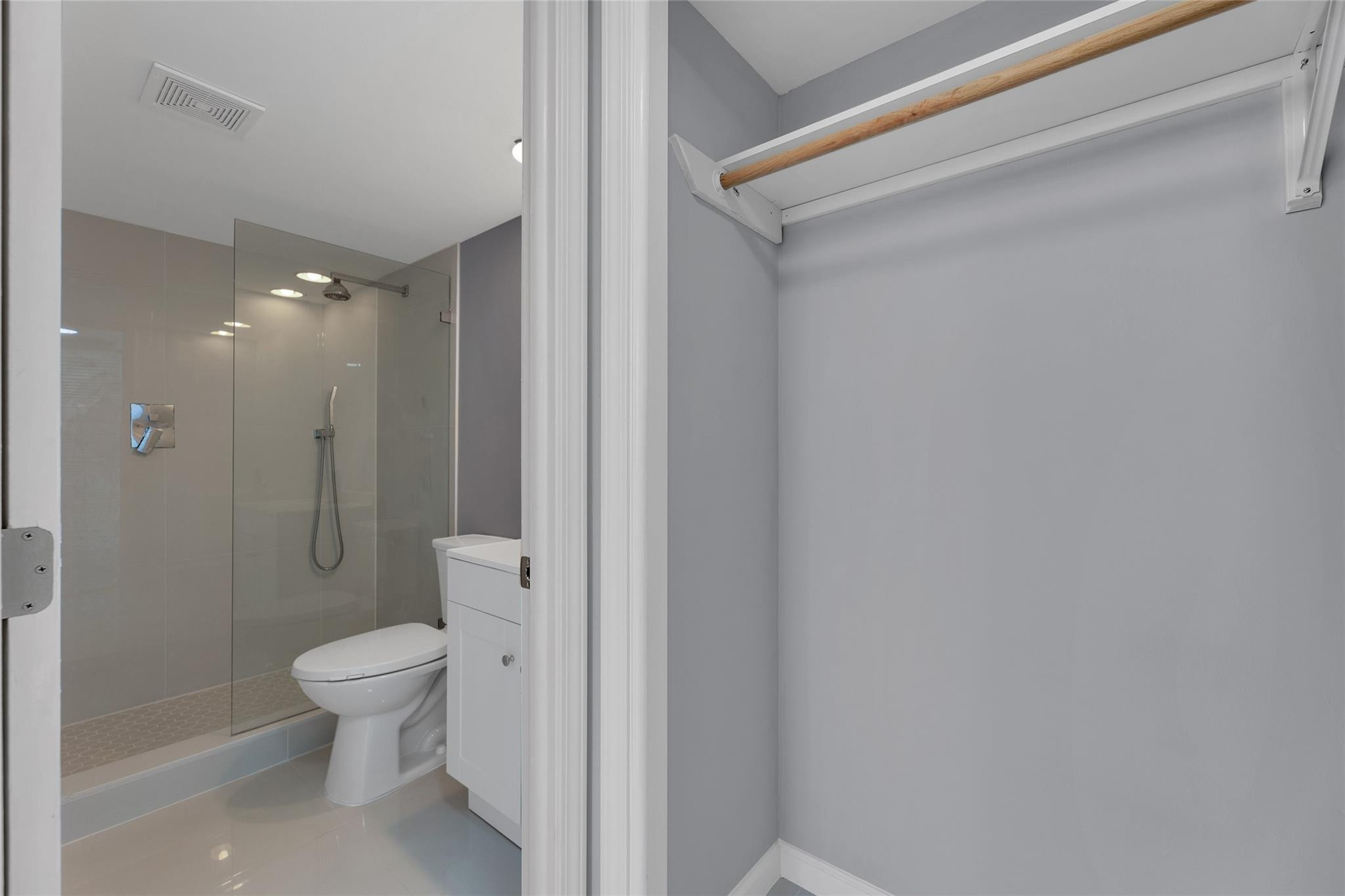 3090 North Course Drive, Unit 609 Pompano Beach, FL 33069 - Photo 25 of 44 a bathroom with a granite countertop sink a toilet and shower