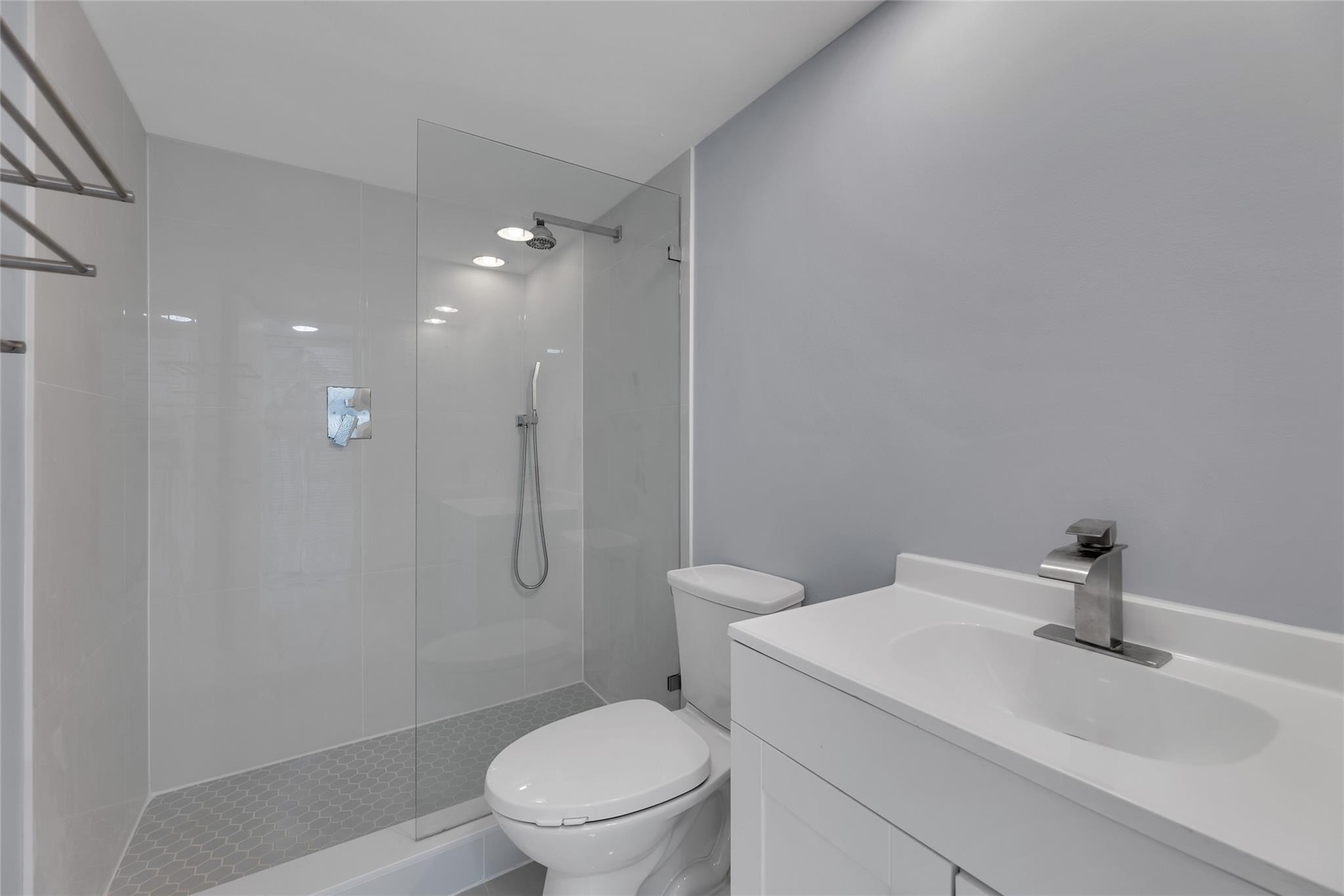 3090 North Course Drive, Unit 609 Pompano Beach, FL 33069 - Photo 26 of 44 a white toilet sitting next to a bathroom sink
