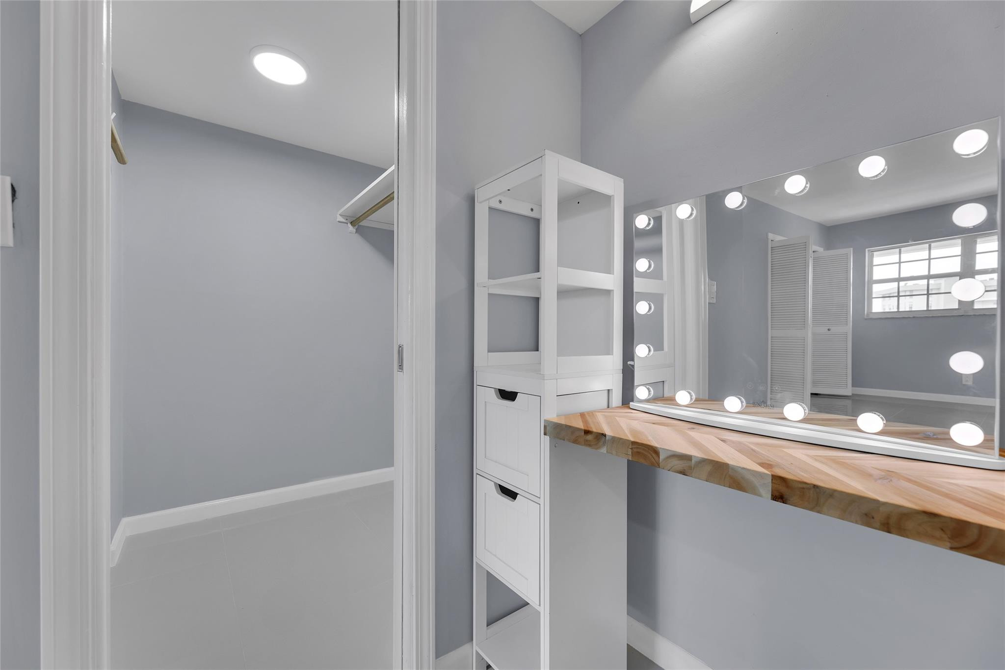 3090 North Course Drive, Unit 609 Pompano Beach, FL 33069 - Photo 30 of 44 a bathroom with a double vanity sink and a mirror