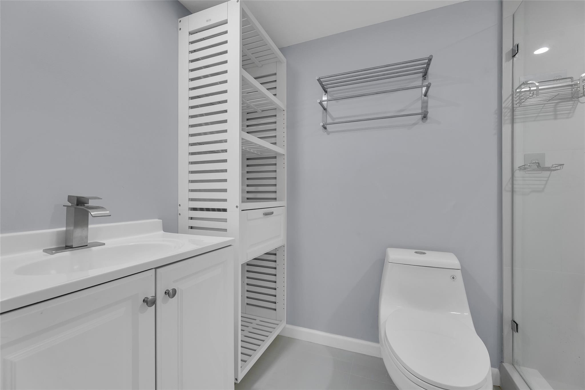 3090 North Course Drive, Unit 609 Pompano Beach, FL 33069 - Photo 32 of 44 a bathroom with a toilet sink and mirror