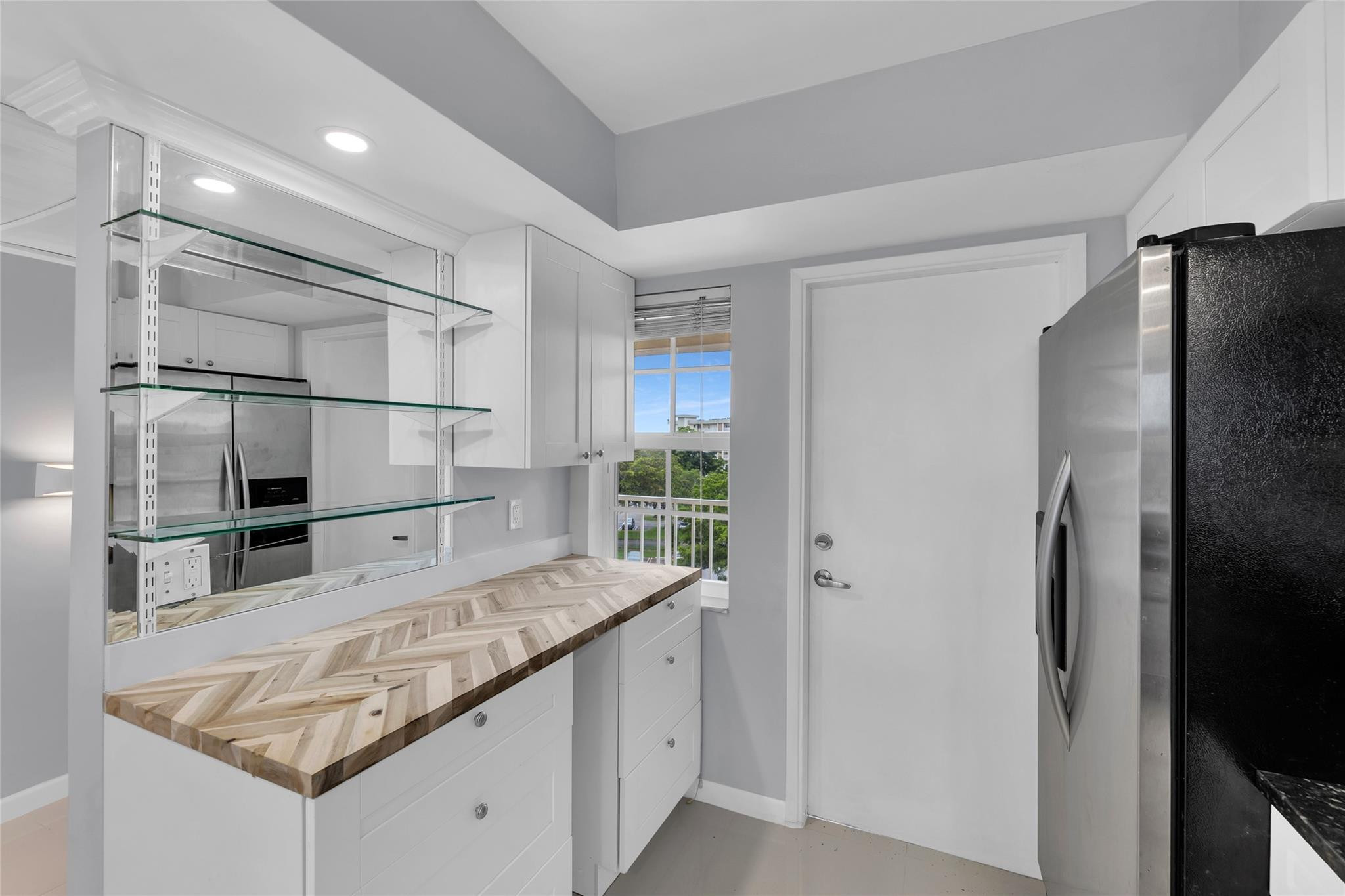 3090 North Course Drive, Unit 609 Pompano Beach, FL 33069 - Photo 6 of 44 a kitchen with granite countertop a refrigerator and stove