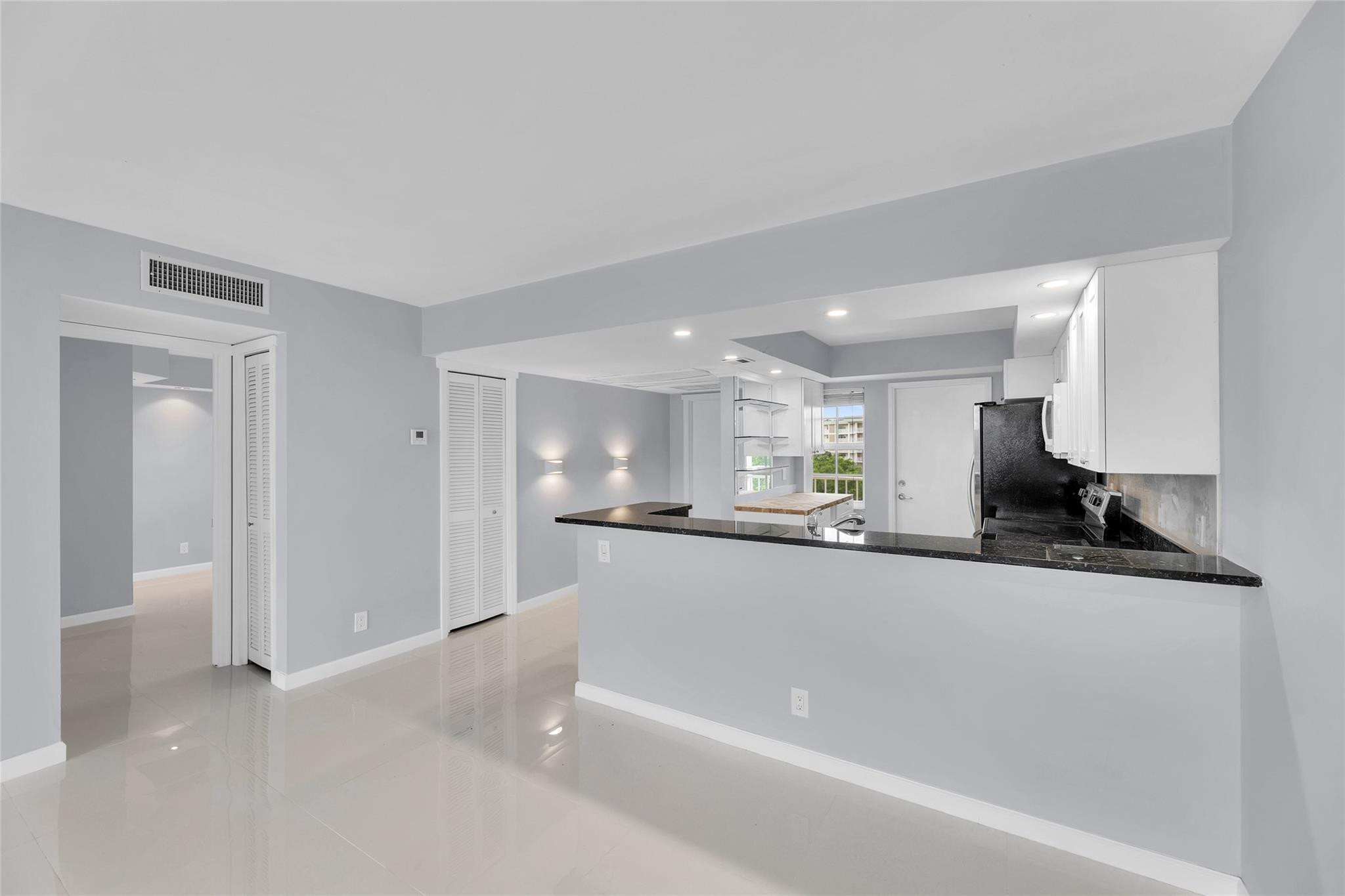 3090 North Course Drive, Unit 609 Pompano Beach, FL 33069 - Photo 10 of 44 a large white kitchen with a sink