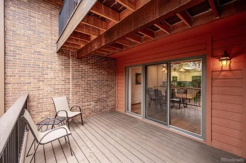 a view of a patio with table and chairs and wooden floor