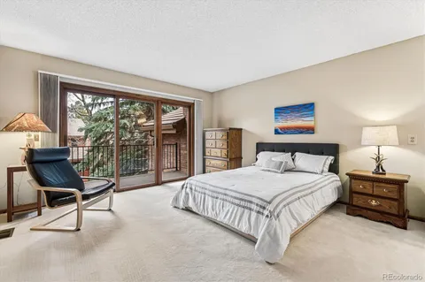 a bedroom with a large bed and a large window