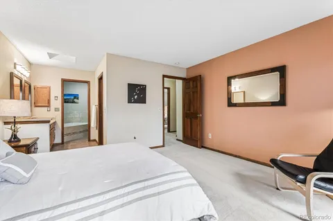 a bedroom with a bed and a chair