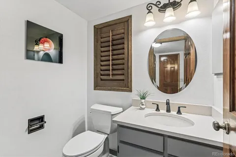 a bathroom with a toilet a sink and a mirror