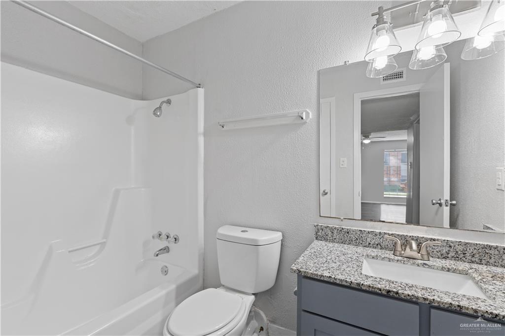 2425 Barnard Road, Unit A15 Brownsville, TX 78520 - Photo 11 of 16 Full bathroom featuring shower / bathing tub combination, vanity, ceiling fan, and toilet