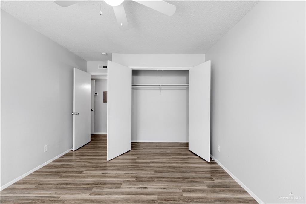 2425 Barnard Road, Unit A15 Brownsville, TX 78520 - Photo 12 of 16 Unfurnished bedroom featuring hardwood / wood-style floors, a closet, and ceiling fan