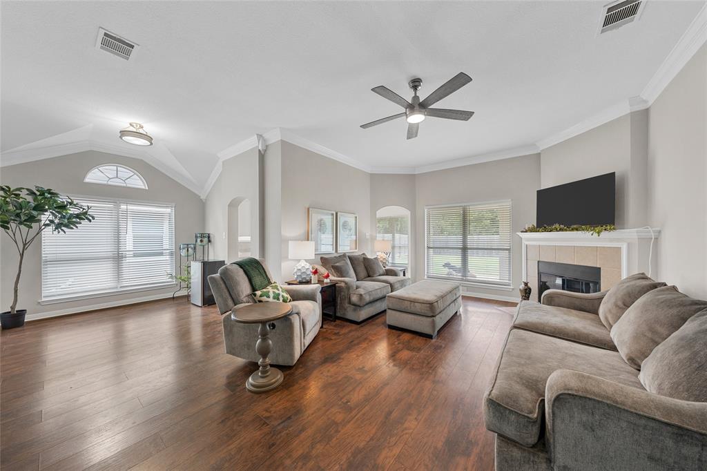 10124 Bunting Drive Waco, TX 76708 - Photo 2 of 18 a living room with furniture a fireplace and a flat screen tv