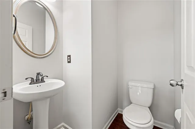 a white toilet sitting next to a bathroom sink