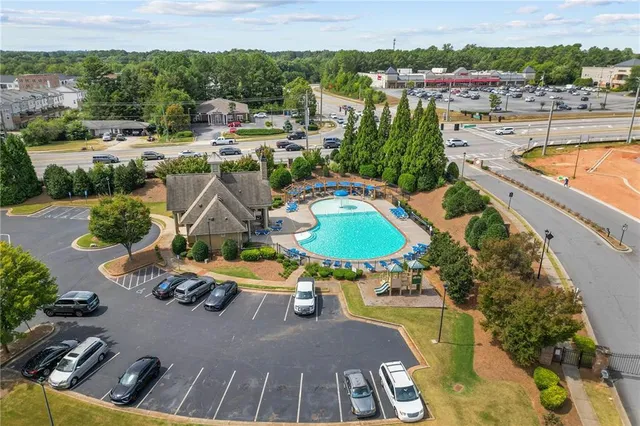 a view of a swimming pool with a patio and a garden