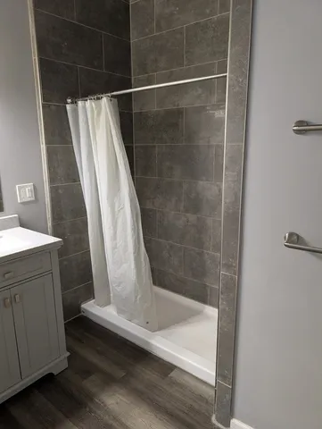 a white toilet sitting next to a shower