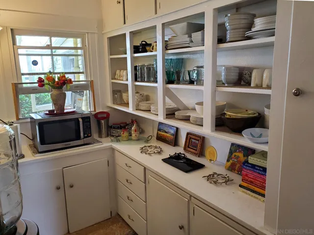 a bed sitting in a bedroom next to a lamp with a chandelier