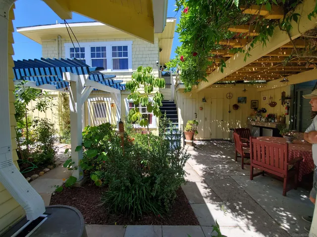 a view of a house with backyard and sitting area