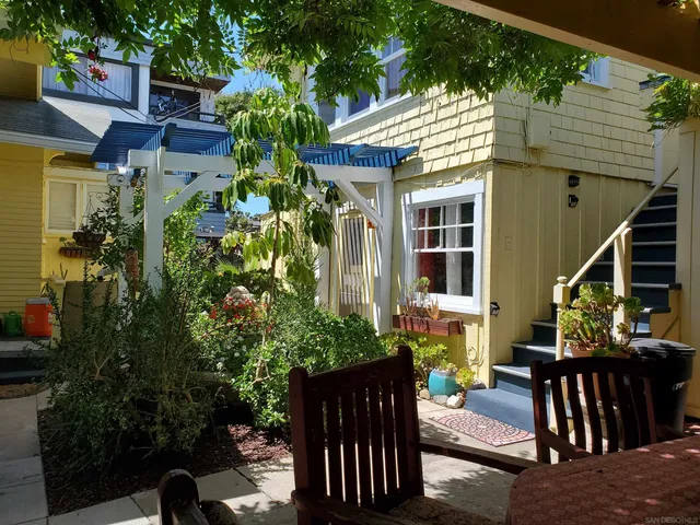 a view of a patio with table and chairs and potted plants