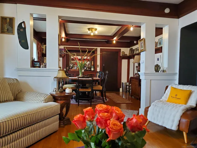 a living room with furniture a rug and white walls