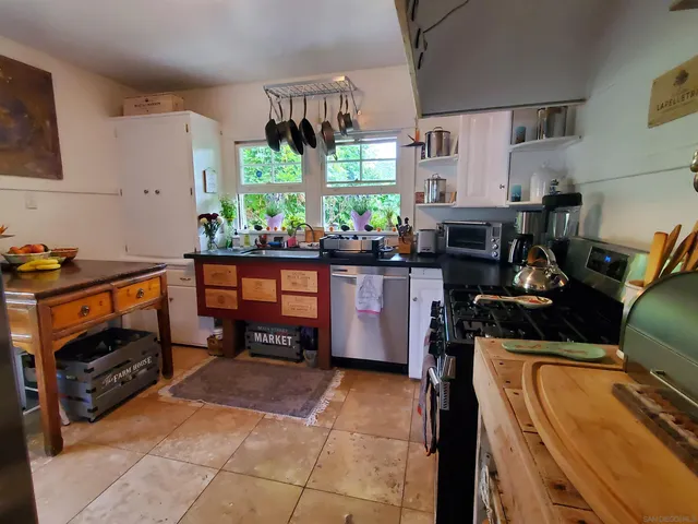 a kitchen with stainless steel appliances kitchen island granite countertop a sink and counter space