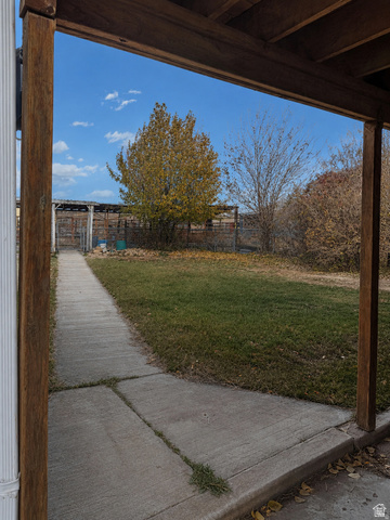 655 Molen Road Ferron, UT 84523 - Photo 16 of 18 Landscaped grounds with a concrete pathway and mature trees