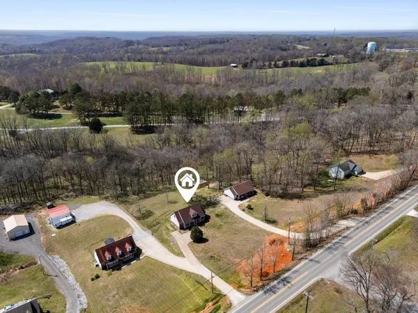 an aerial view of a house with a swimming pool