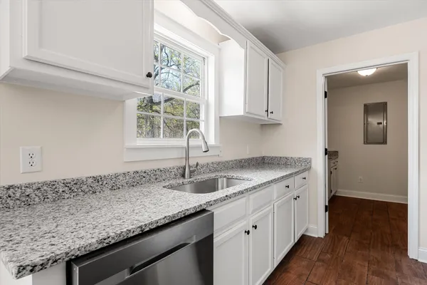 a kitchen with stainless steel appliances granite countertop a stove microwave and sink