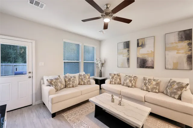 a living room with furniture and a large window