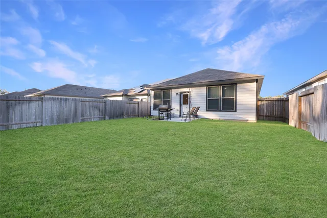 a front view of a house with a garden and yard