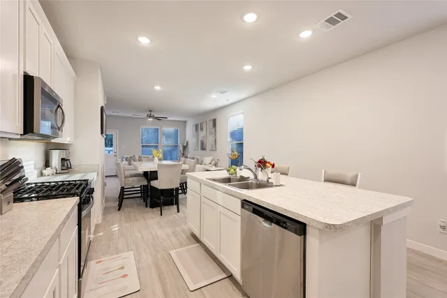 a kitchen with a sink and cabinets