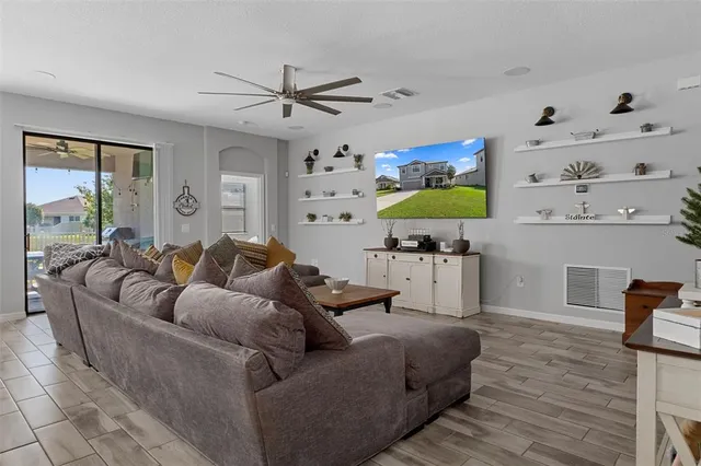 a view of a dining room with furniture and a chandelier