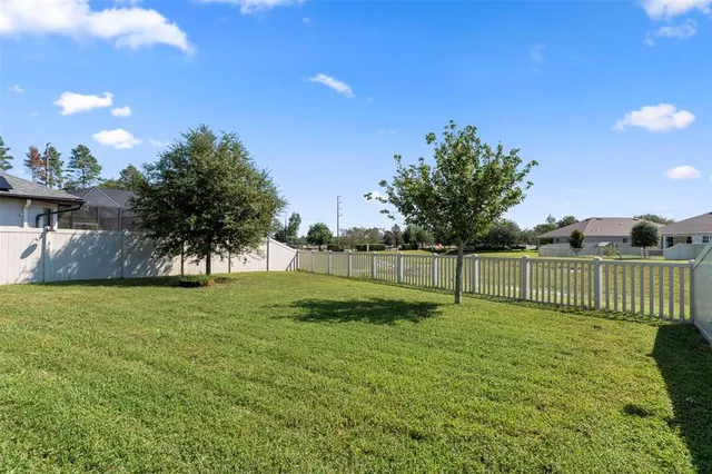 a front view of a house with a yard patio and swimming pool