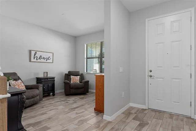a living room with furniture kitchen view and a table