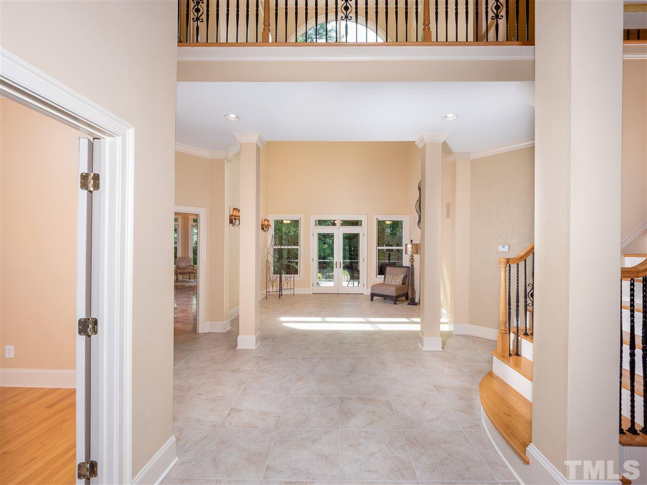 113 Bathgate Lane Cary, NC 27513 - Photo 3 of 30 Leaded glass mahogany doors open to foyer, dining room, living room and gathering area