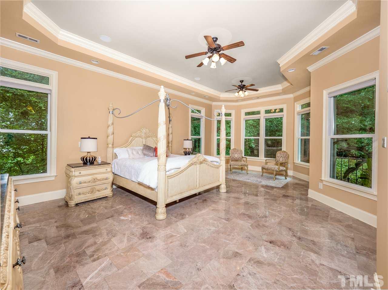 113 Bathgate Lane Cary, NC 27513 - Photo 6 of 30 Expansive main floor owners' suite features a sitting area with a wonderful view of a variety of trees and flowers