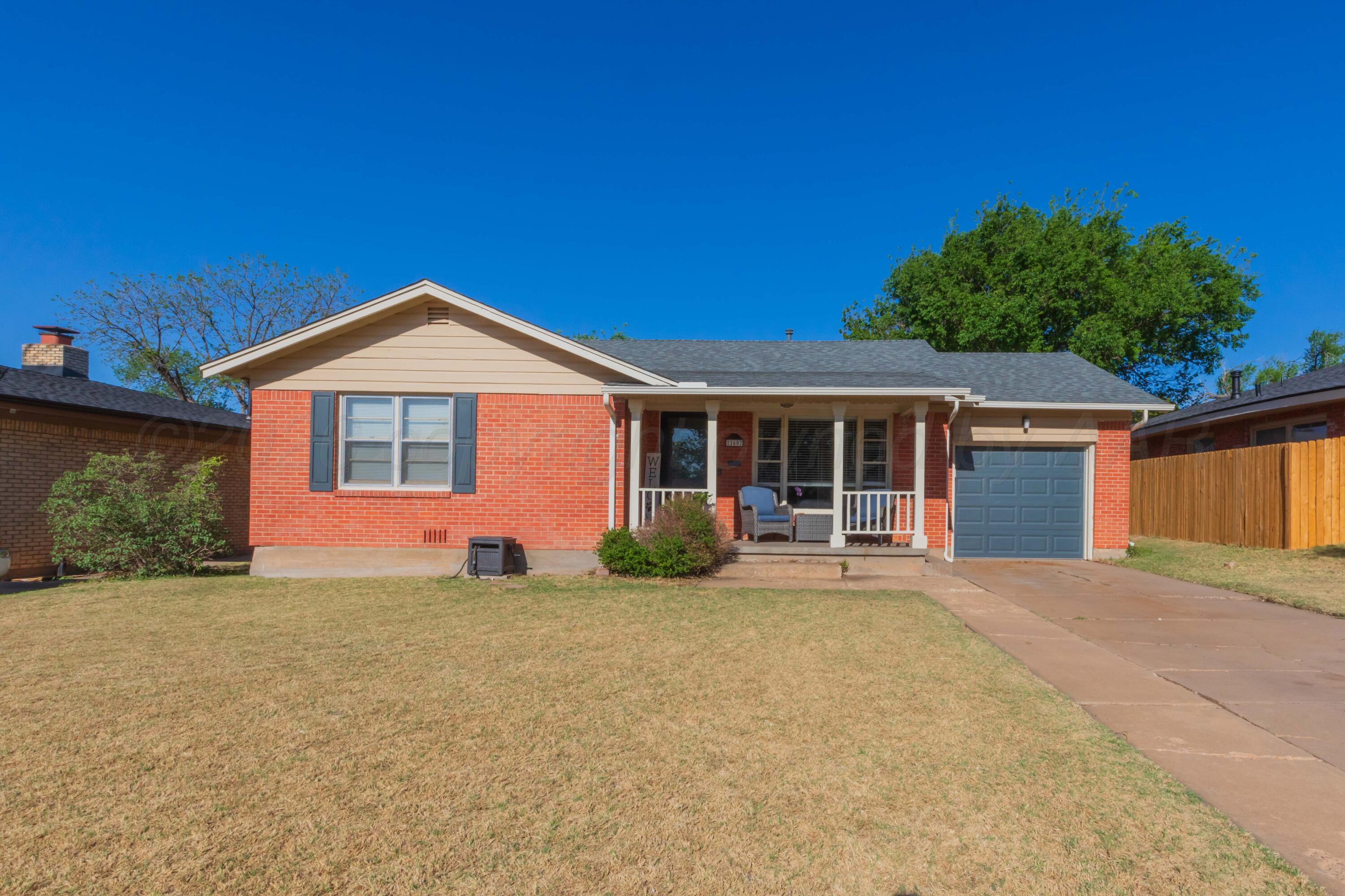 1602 Mustang Street Amarillo, TX 79102 - Photo 1 of 36 front view of a house with a garden and yard