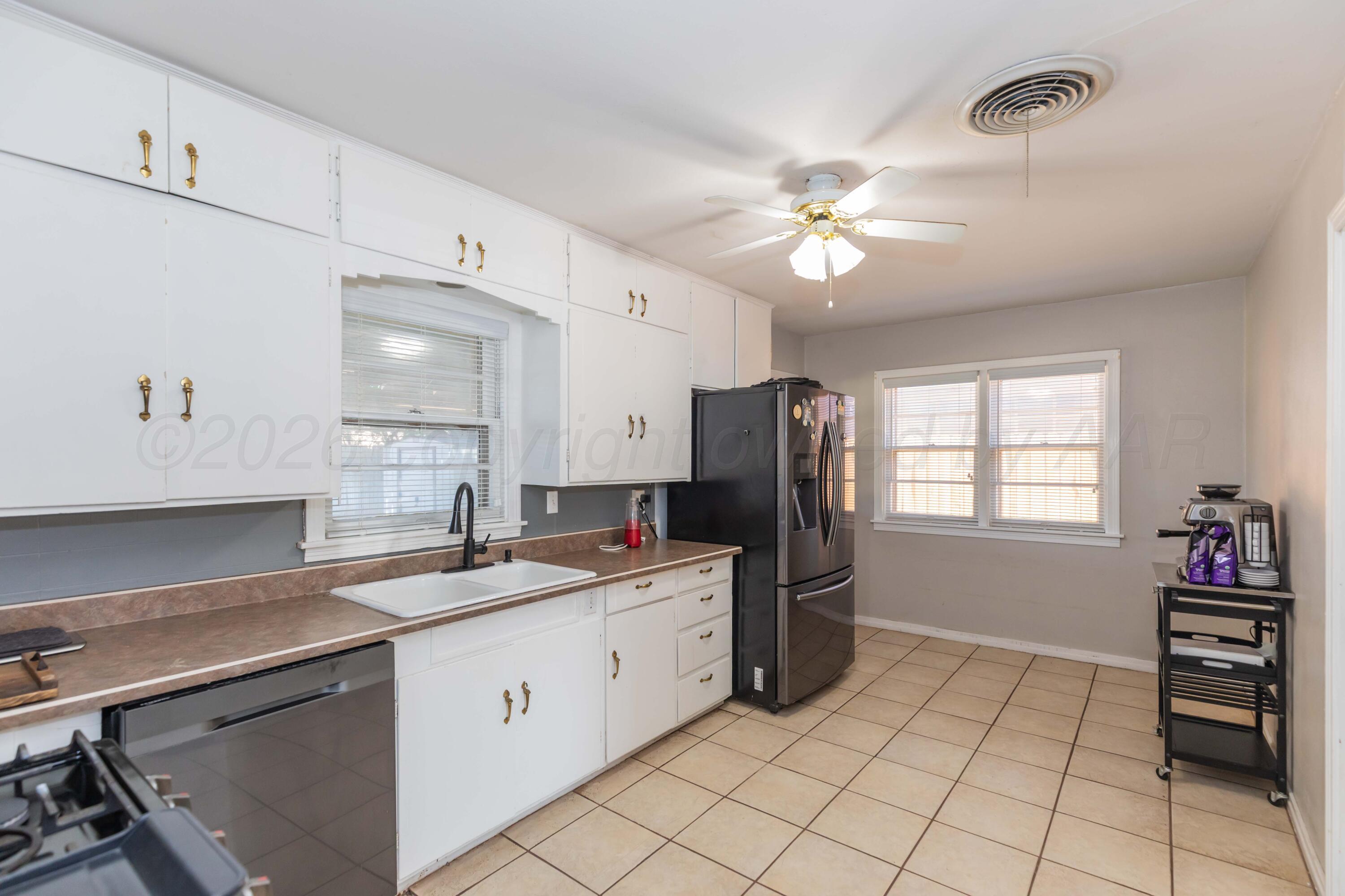 1602 Mustang Street Amarillo, TX 79102 - Photo 12 of 36 a kitchen with a stove a sink and a refrigerator