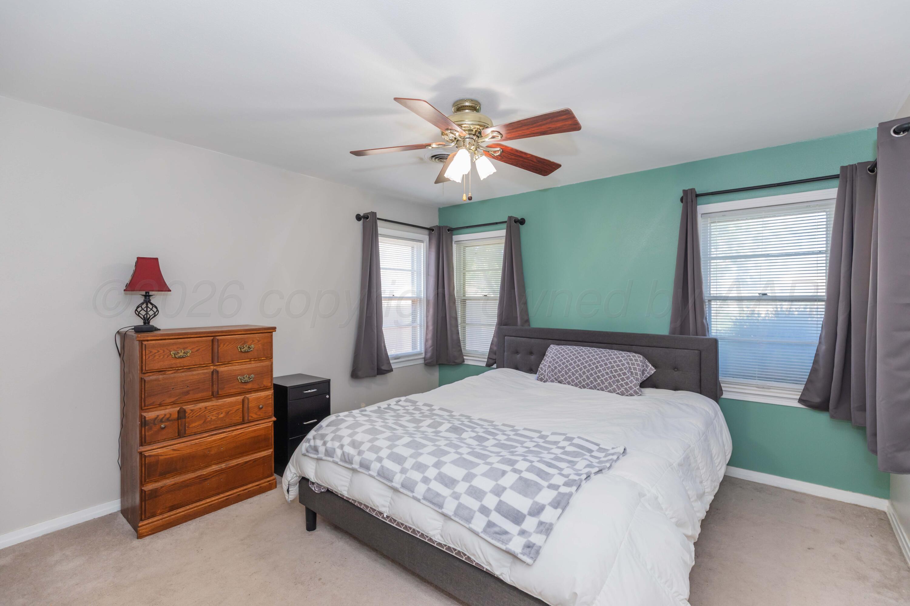 1602 Mustang Street Amarillo, TX 79102 - Photo 21 of 36 a bedroom with a bed and a dresser