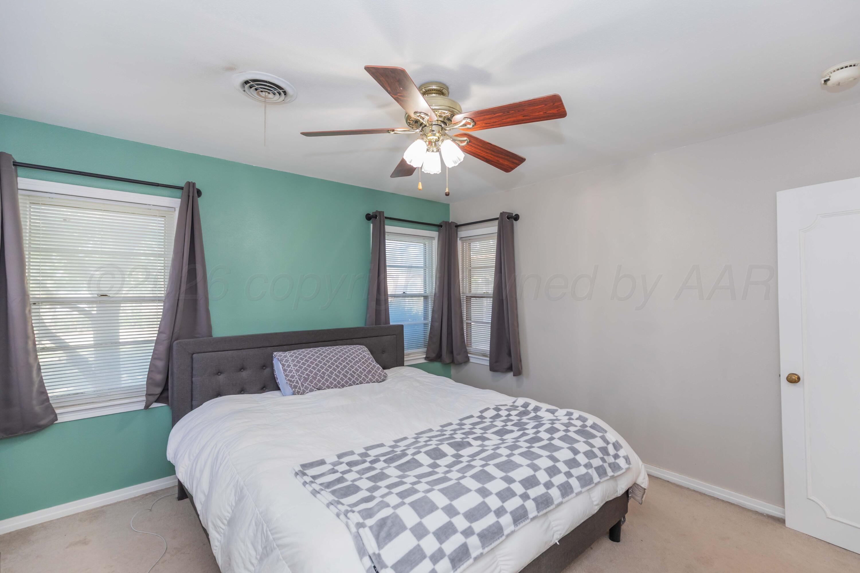 1602 Mustang Street Amarillo, TX 79102 - Photo 22 of 36 a bedroom with a large bed and a window
