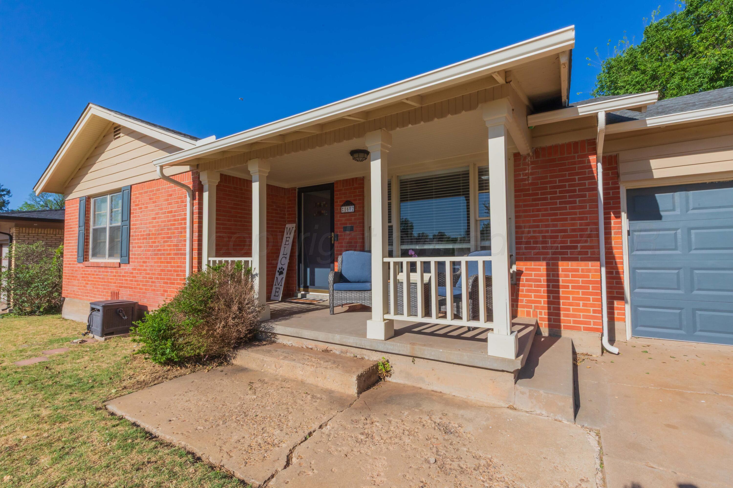 1602 Mustang Street Amarillo, TX 79102 - Photo 3 of 36 a backyard of a house with deck and outdoor seating
