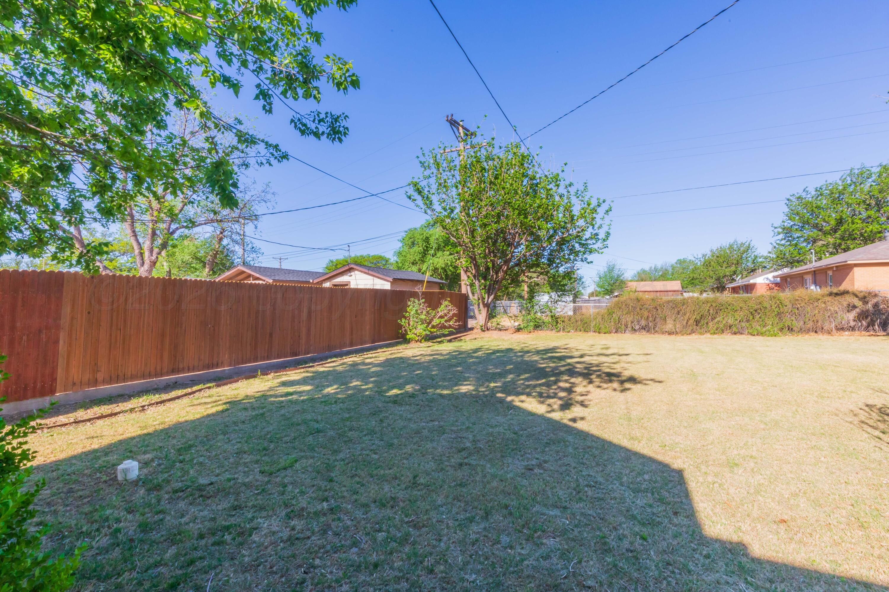 1602 Mustang Street Amarillo, TX 79102 - Photo 32 of 36 a view of a yard with wooden fence