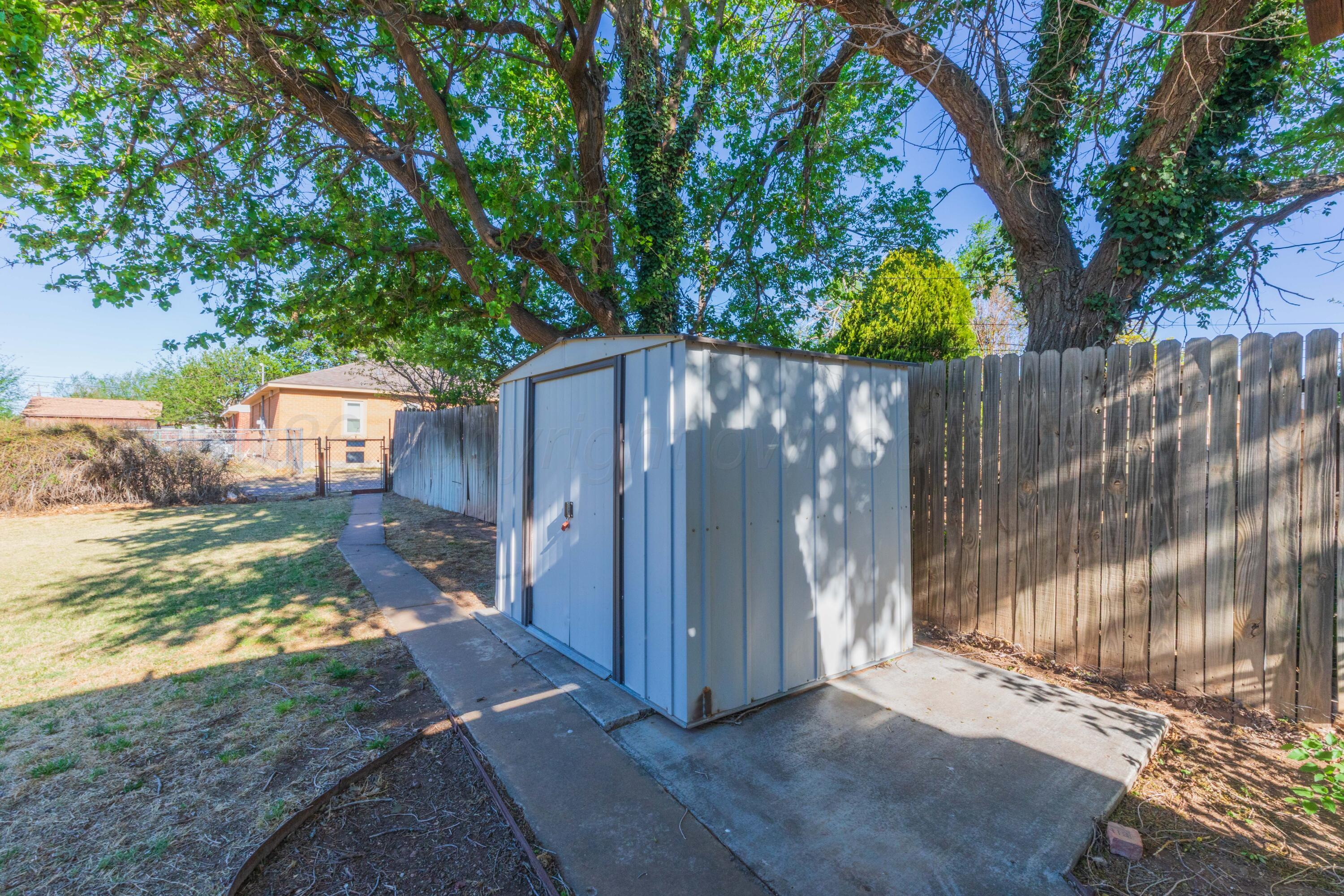 1602 Mustang Street Amarillo, TX 79102 - Photo 35 of 36 a view of a small yard with wooden fence