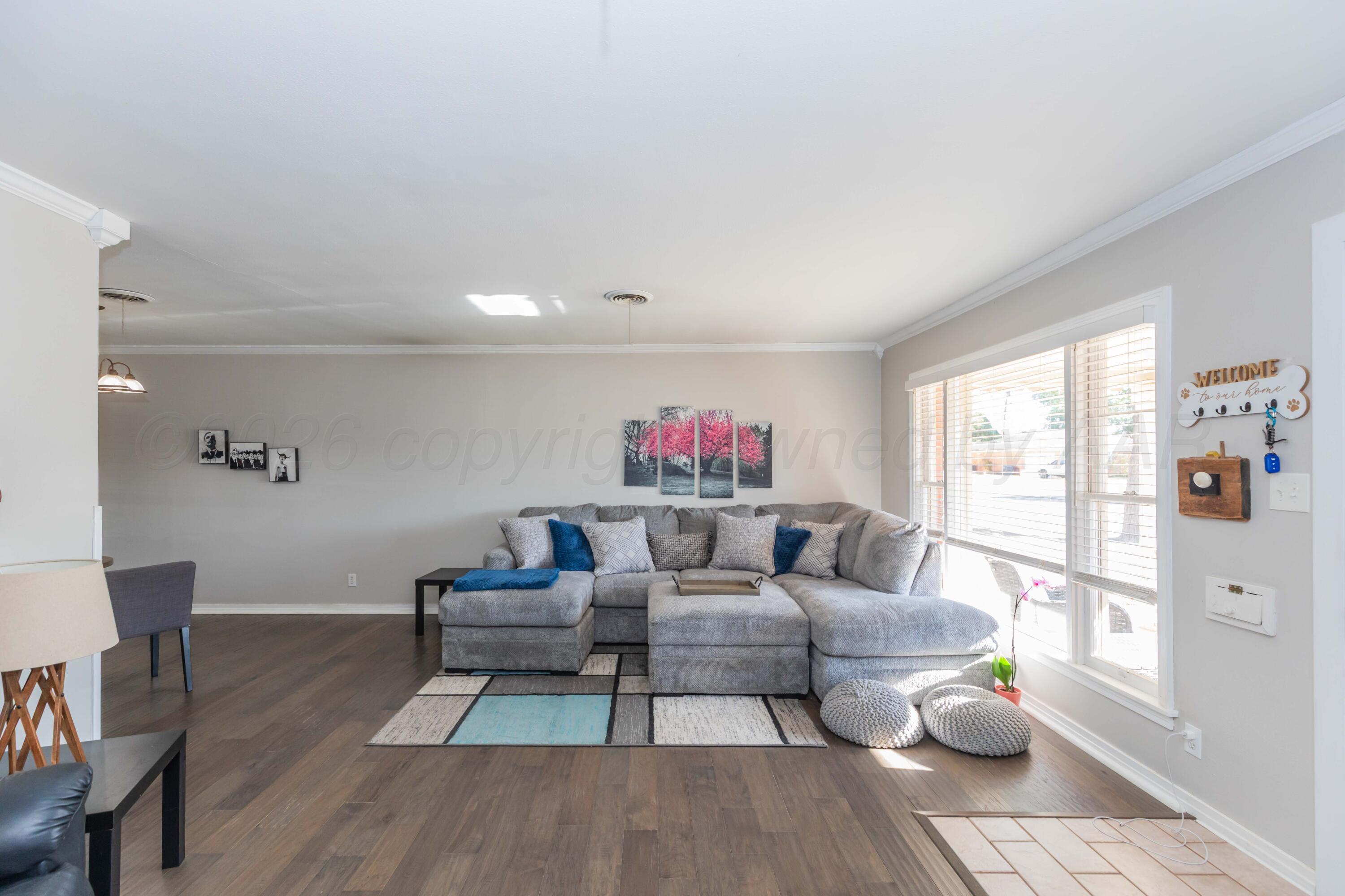 1602 Mustang Street Amarillo, TX 79102 - Photo 7 of 36 a living room with furniture and a wooden floor
