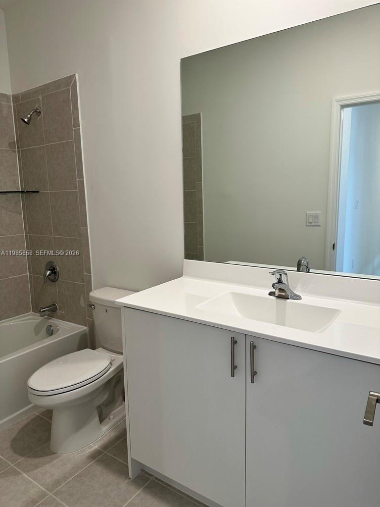 13254 Southwest 285th Street, Unit 13254 Homestead, FL 33033 - Photo 8 of 10 a bathroom with a sink a toilet and shower