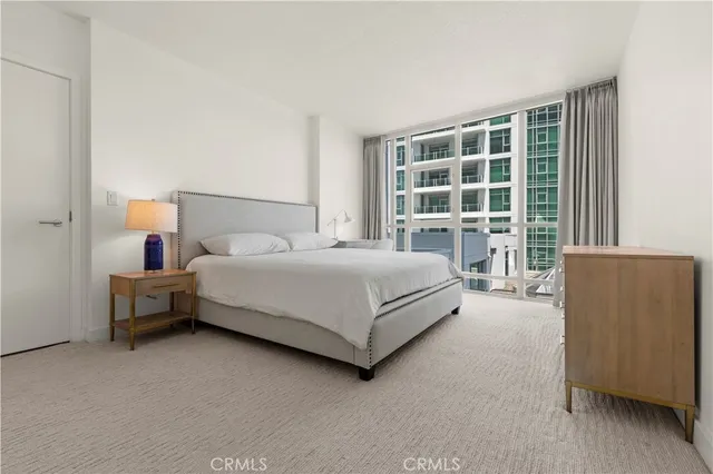 a bedroom with a bed and a large window